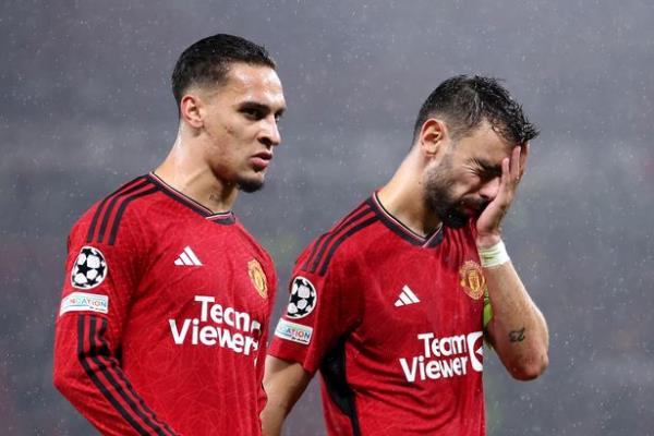 Antony and Bruno Fernandes of Manchester United look dejected following the team's defeat during the UEFA Champions League match between Manchester United and Galatasaray A.S at Old Trafford on October 03, 2023 in Manchester, England.