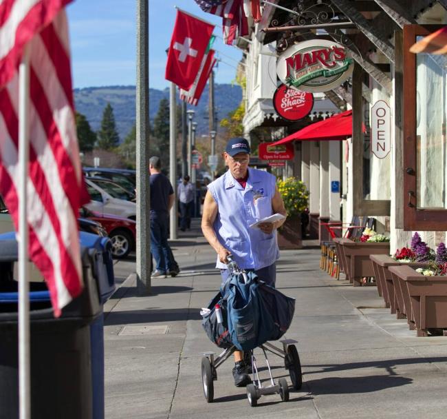 Mail carrier Butch Alvarez, shown in this 2018 file photo,  delivered mail on the So<em></em>noma Plaza plaza for 33 years of his 40-year career. He died July 7 after a battle with cancer. He was 69. (John Burgess / The Press Democrat file, 2018)