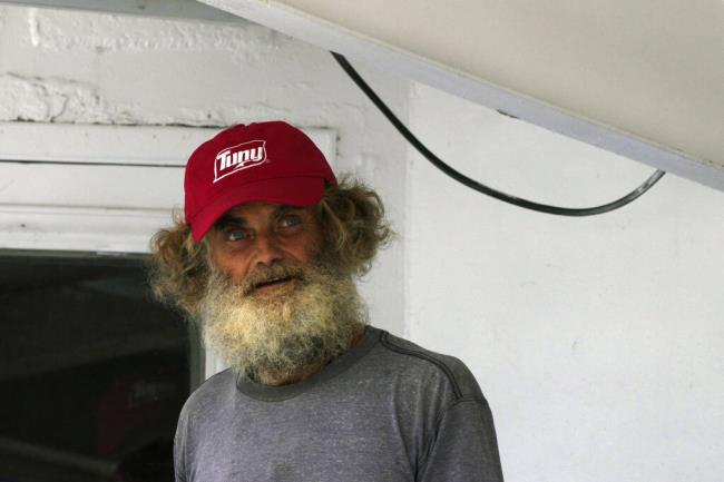 Australian Timothy Lyndsay Shaddock looks out from the tuna boat "Maria Delia" that rescued him and his dog Bella, as he arrives to port in Manzanillo, Mexico, Tuesday, July 18, 2023. After being adrift with his dog for three months, the pair were rescued by the Mexican boat from his incapacitated catamaran in the Pacific Ocean some 1,200 miles from land. (AP Photo/Fernando Llano)