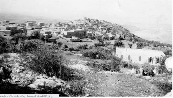 A black and white photo of houses in a village.