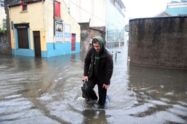 While the worst of the flooding was in East Cork, other areas were affected too. Here, a pedestrian makes his way through floodwaters on Rutland St off South Terrace in Cork City during Storm Babet on Wednesday morning. Picture: Larry Cummins