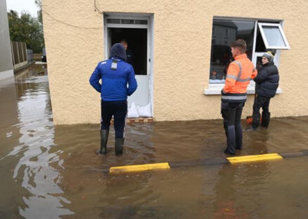  People assessing the damage and clearing up after the Storm Babet flooding in Rathcormac, Co Cork on Wednesday. Picture; Eddie O'Hare