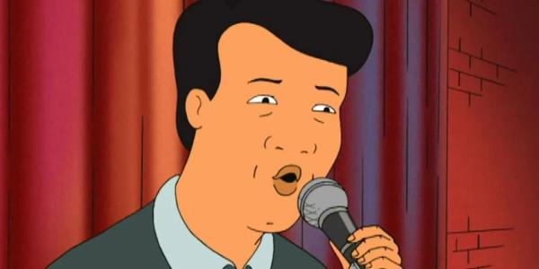 Kahn singing on the mic in King of the Hill